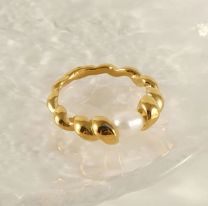 Detailed macro view of 18k gold plated stainless steel ring with white natural pearl