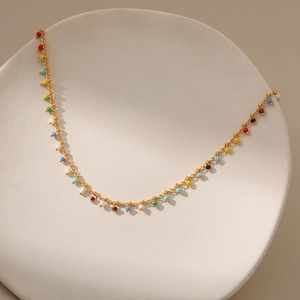 Exotic 18K gold-plated copper chain necklace with colorful beads on white ceramic tray