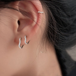Sparkling wave-shaped silver hoop earrings and ear cuff with micro-set zircon stones