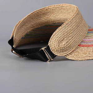 Close-up of raffia sun visor featuring rainbow stripes and adjustable elastic strap