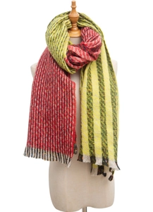 Detail of knit scarf with red texture, yellow-green stripes and elegant fringe accents