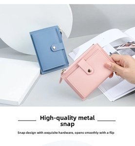 Detail of lychee leather card holder with secure metal snap button and zipper pocket