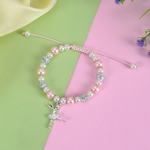Detail of adjustable beaded bracelet with ballet girl pendant and shiny rhinestone balls