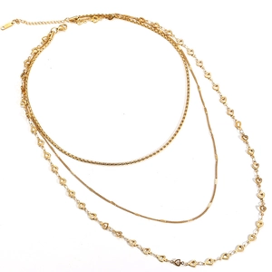 Detailed view of 18K gold plated triple layered necklace with heart charms on white background