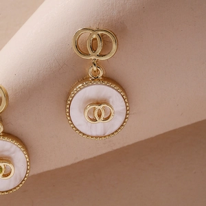 Elegant gold-tone geometric double circle earrings with white mother-of-pearl inlay
