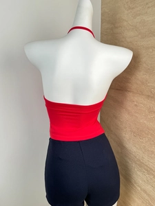 Detail view of red halter top back with elastic knit fabric and cropped waist design
