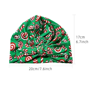 Green Christmas baby turban hat with candy cane patterns and large decorative bow