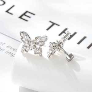 French vintage silver butterfly earrings with sparkling cubic zirconia on a white pedestal