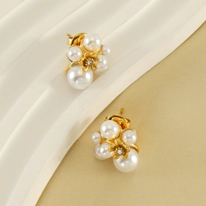 Elegant gold flower stud earrings with white pearls and sparkling zircon accents