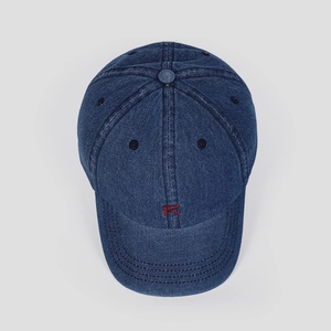 Detail of red embroidered 'R' on dark blue denim baseball cap with reinforced stitching