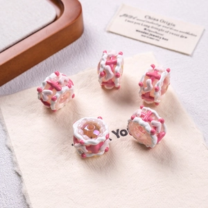 Detailed view of pink and white hand-painted acrylic beads for DIY jewelry making