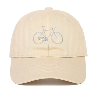 Close-up of a bicycle embroidery on a beige cotton twill baseball cap with fine texture