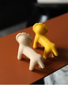 Detail of Nordic ceramic lion figurines in matte beige and glossy ginger yellow glazes
