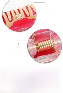 Detail of a large hair claw clip featuring a pink donut print and a strong gold metal spring