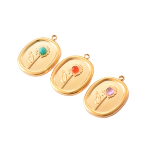 Three gold oval stainless steel sunflower pendants with green, orange, and purple gems