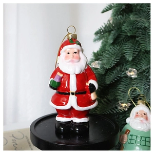 Close-up of a festive red Santa Claus ornament on a black tray with Christmas tree lights