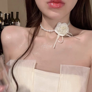 French luxury pearl necklace featuring a 3D white flower and elegant silk ribbon charm