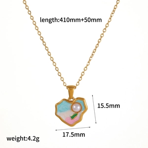 Detail view of gold heart necklace with dimensions and white pearl enamel pendant
