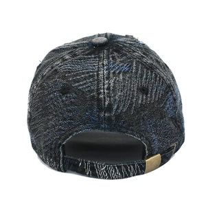 Detail view of the distressed denim baseball cap with an adjustable bronze metal buckle
