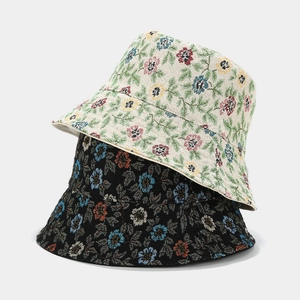 Floral reversible bucket hat featuring vintage jacquard weave patterns in black and beige