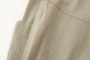 Detailed macro view of beige linen-like fabric with high-quality double-stitched seams