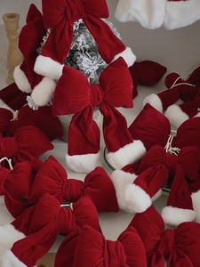 Detail of red velvet Christmas bows with white faux fur edges for tree decoration