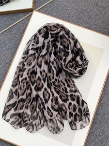 Detail of leopard print voile scarf with soft texture and classic animal pattern