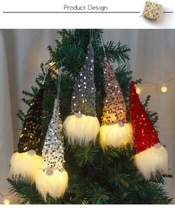 Five glowing Christmas gnome ornaments with sequin hats hanging on a festive Xmas tree