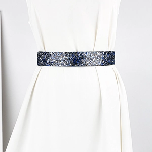 Close-up of wide elastic rhinestone belt with blue, silver, and black glitter sequins