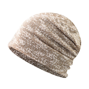 Detailed close-up of light brown and white knit pattern on a soft slouchy beanie