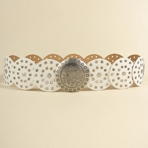 Detailed view of white leather waist belt with silver metal grommets and carved buckle