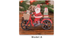 Detail view of wooden Santa riding a bicycle ornament with XMAS gifts and bear on wood