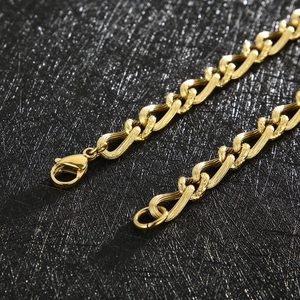 Detail of golden twist chain necklace showing textured metal links and lobster clasp