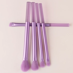 Detailed view of 5-piece purple makeup brush set with crystal glitter liquid handles