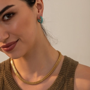 Detail shot of vintage 18K gold flat snake chain with turquoise and pearl hoop earrings