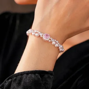 Elegant double-layered pearl bracelet featuring a pink gemstone centerpiece and silver finish