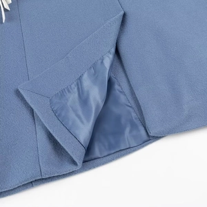 Detail shot of blue woolen coat back slit with premium lining and tassel trim details