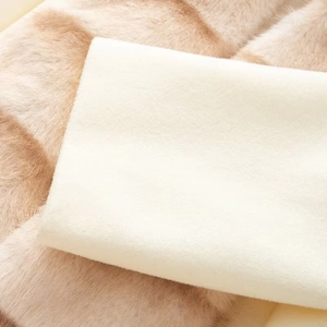 Detail shot of white and coffee faux fur fabric showing soft texture and high-density pile