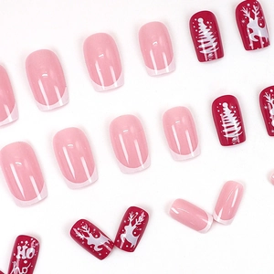 Christmas press-on nails set with red reindeer, white snowflake, and French pink tips