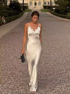 Detailed lace trim on champagne satin maxi dress with V-neckline on a female model