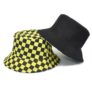 Reversible bucket hat set with yellow plaid and solid black design for outdoor sun protection
