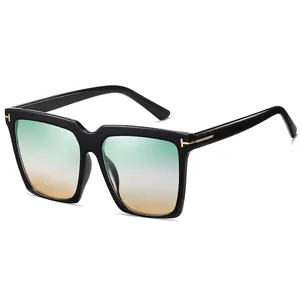 Occhiali da sole quadrati oversize con montatura nera, lenti sfumate e dettaglio a T in metallo