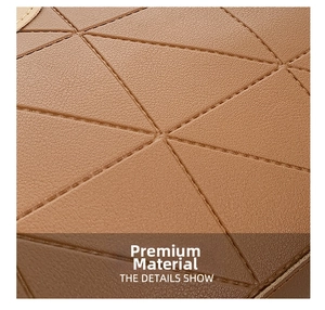 Detailed close-up of brown synthetic leather with geometric stitching on a tote bag
