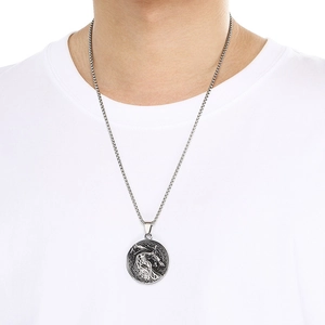 Nordic Nidhogg dragon pendant in silver finish on box chain worn over white tee