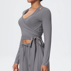 Detail of grey yoga set with wrap-tie long sleeve top and high waist drawstring pants