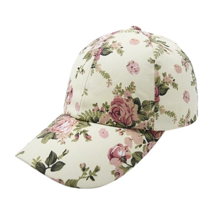 Detail of vintage floral baseball cap featuring pink rose prints on cream canvas fabric
