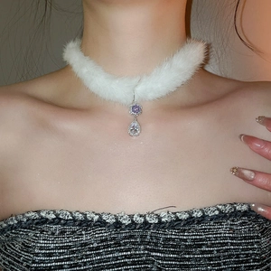 Detail of plush choker with purple flower crystal and drop pendant on a model