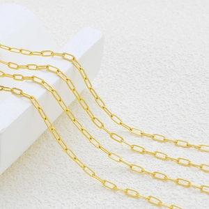 Macro detail of 18K gold-plated oval paperclip chain with matte brushed finish texture