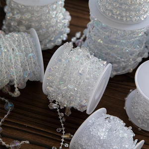 Transparent AB crystal plastic bead chain for Christmas tree decoration on wooden surface