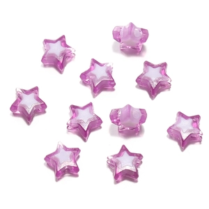 Macro detail of star-shaped acrylic beads in purple and white for DIY crafts